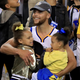 Stephen Curry of the Golden State Warriors celebrates holding his daughters Riley and Ryan after defeating the Cleveland Cavaliers 129-120 in Game 5 to win the 2017 NBA Finals on June 12, 2017 in Oakland, California.